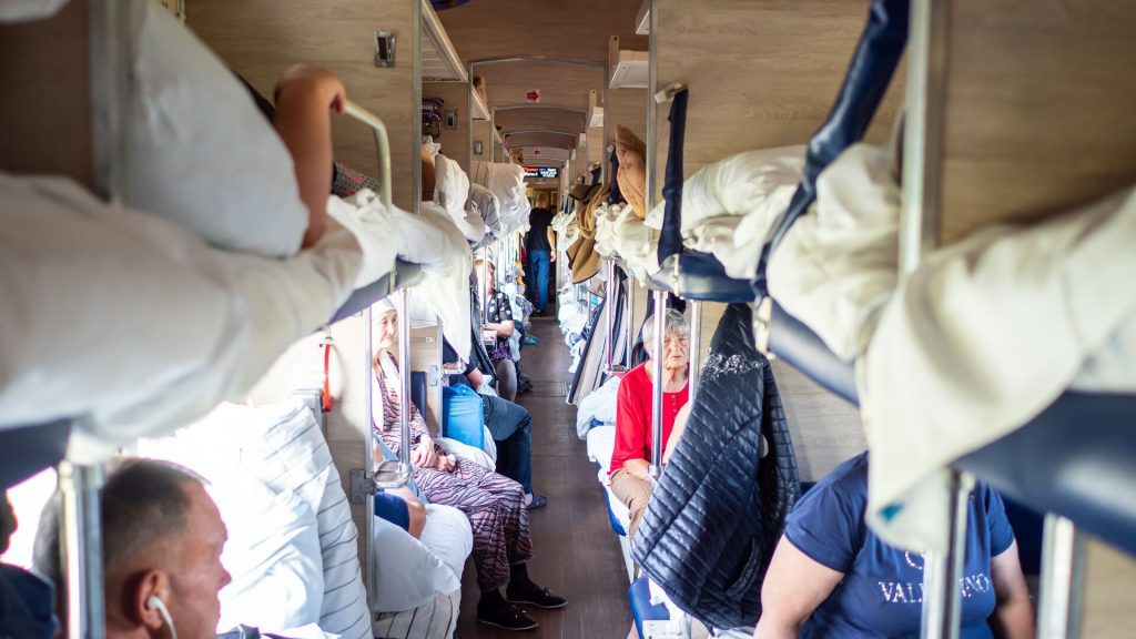 Travellers relaxing in their beds on a sleeper train in Russia