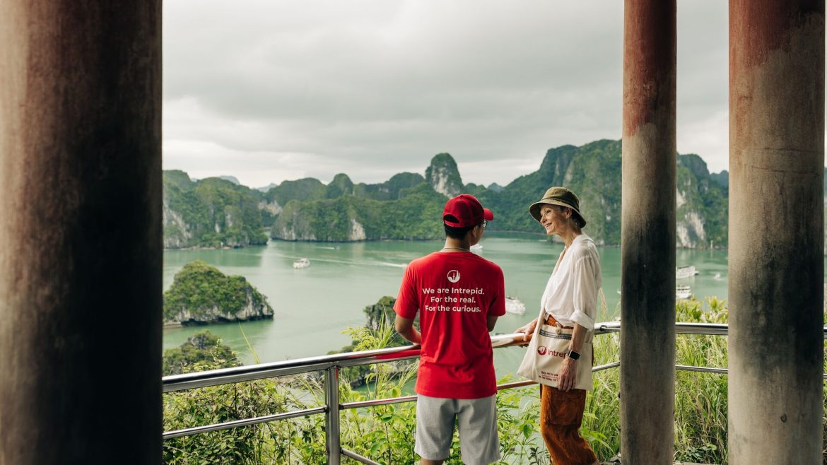 An Intrepid leader and a traveller admire the view of Halong Bay, Vietnam