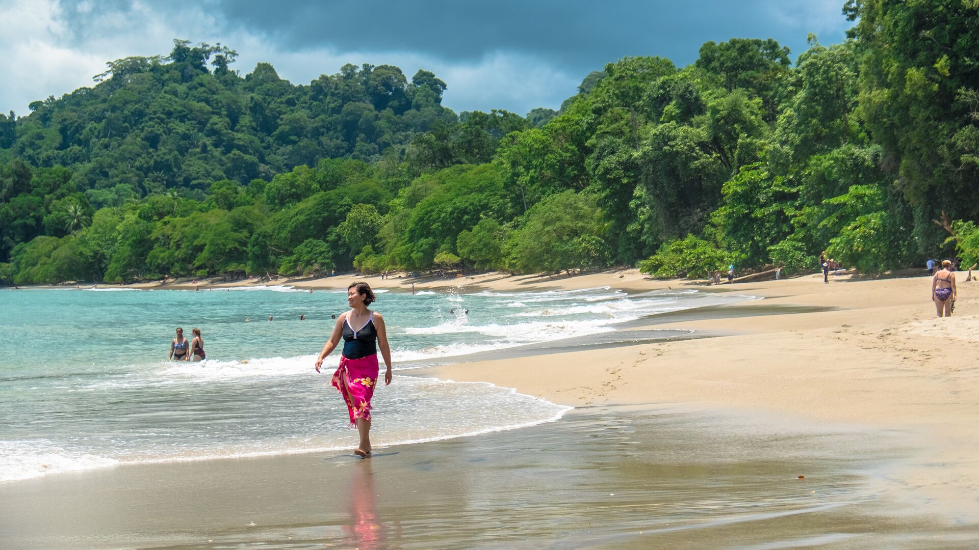 A woman walks along the beach in Costa Rica