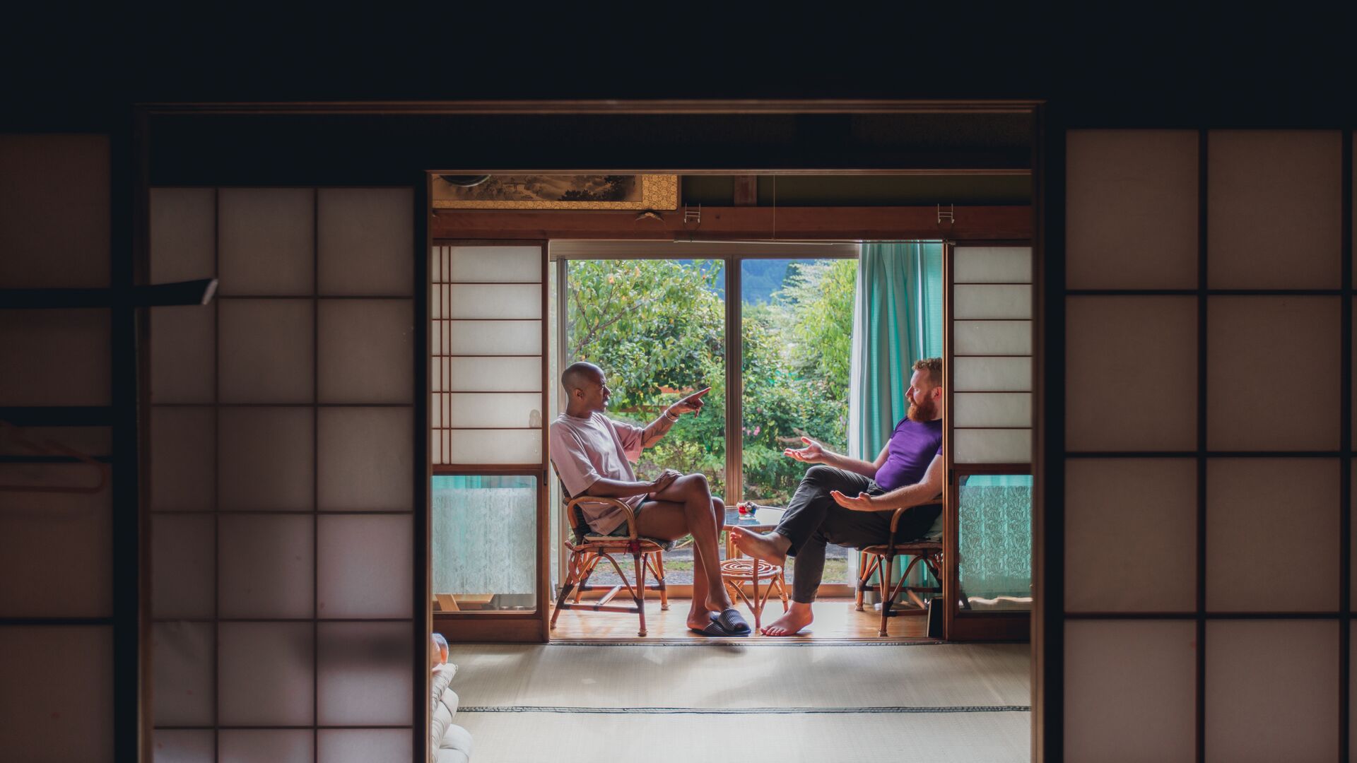 Two travellers chat at a rural Japanese homestay