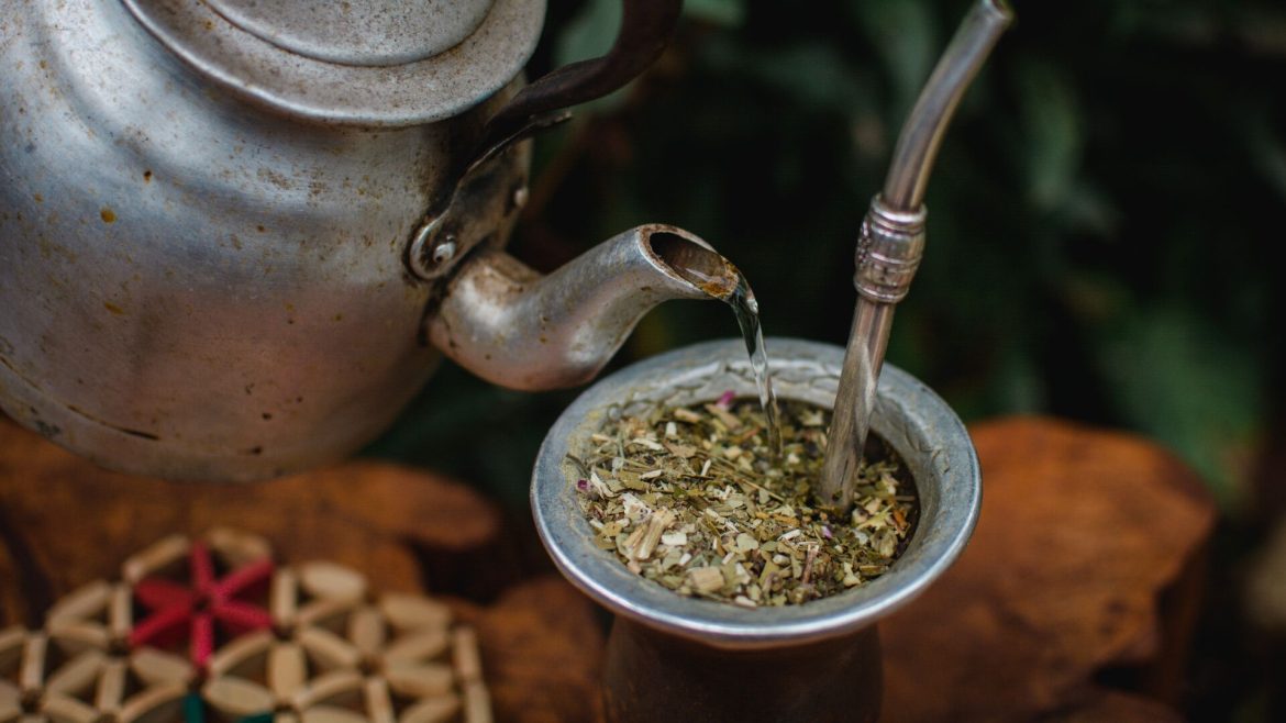 Yerba mate being poured through a strainer