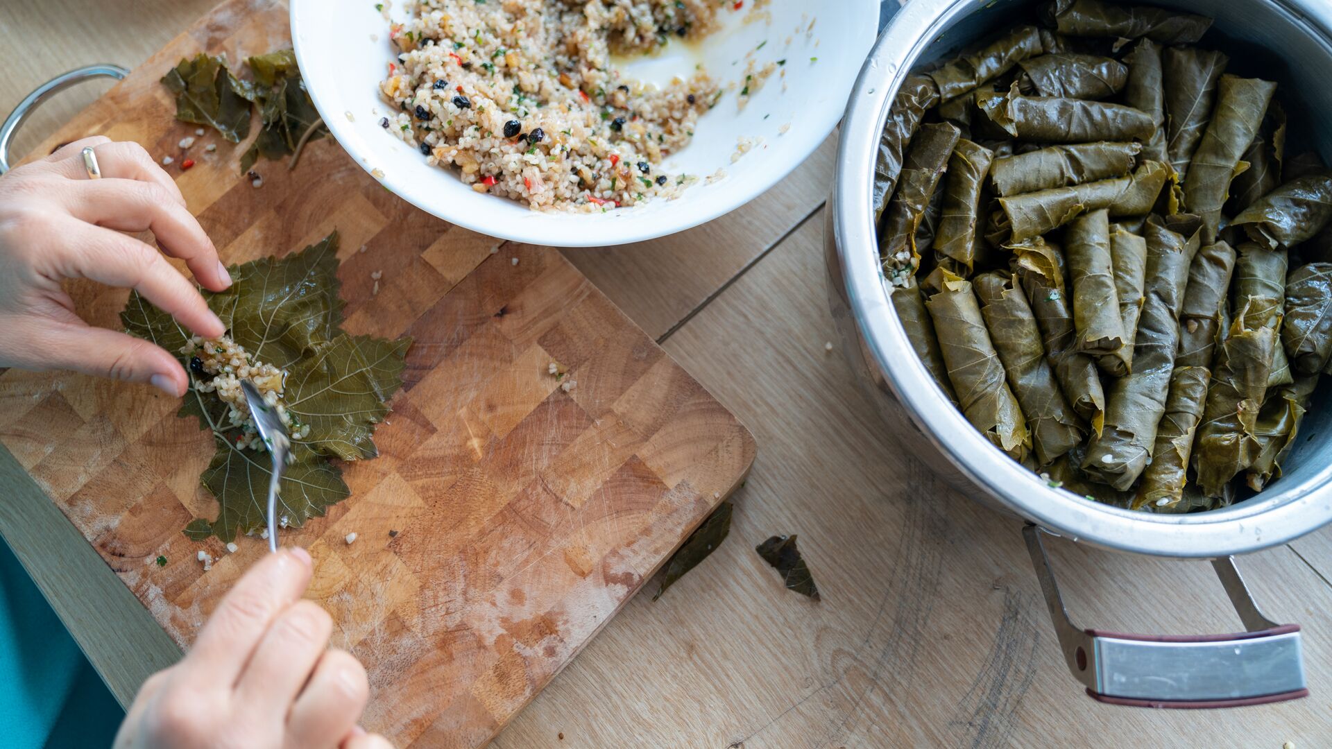 Making traditional Turkish dolma (stuffed vine leaves)