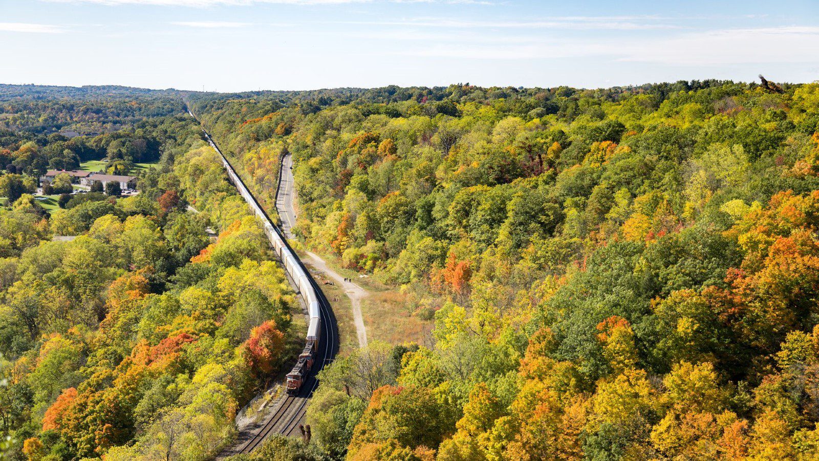 A train meanders through an autumnal forest landscape in Dundas Valley, Southern Ontario, Canada
