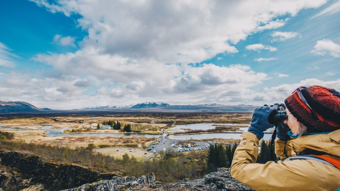 A woman looks out over a classic Iceland vista