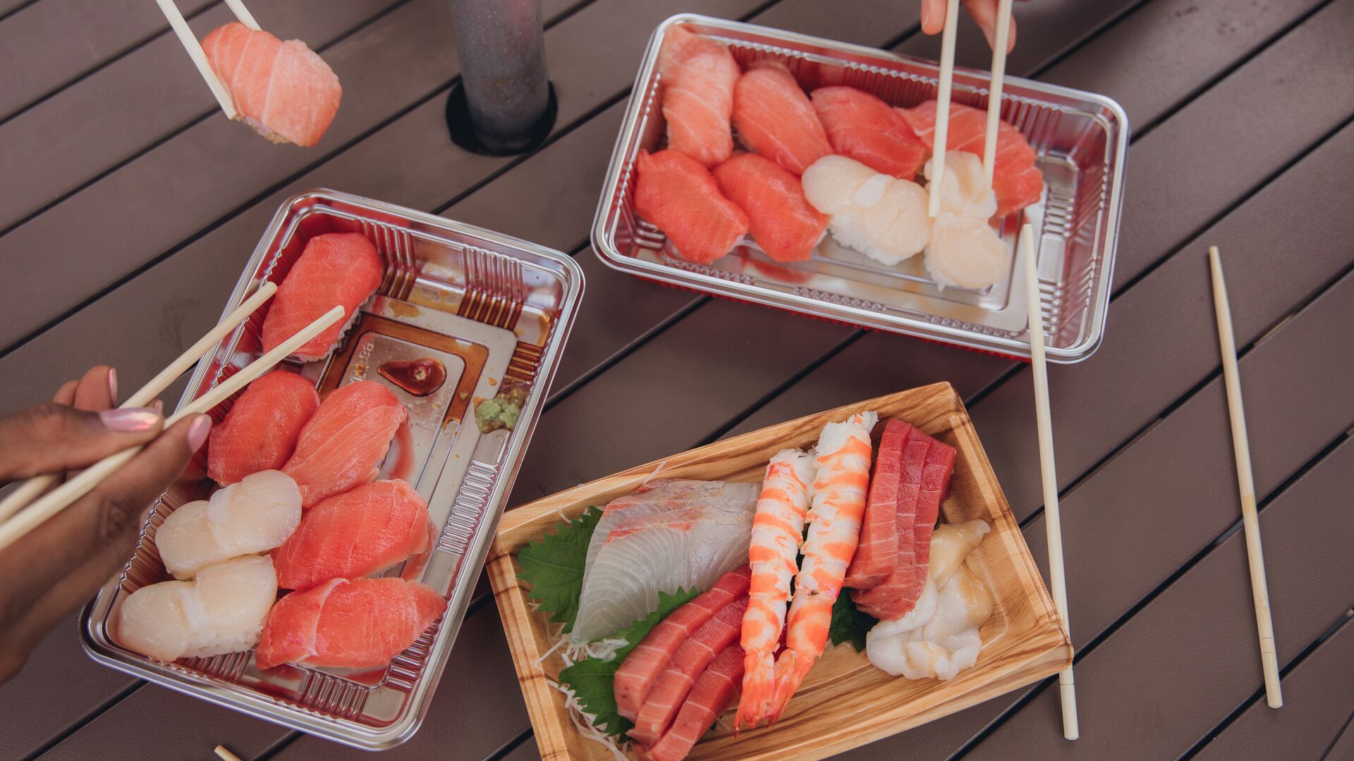 A group eating sushi with chopsticks in Japan