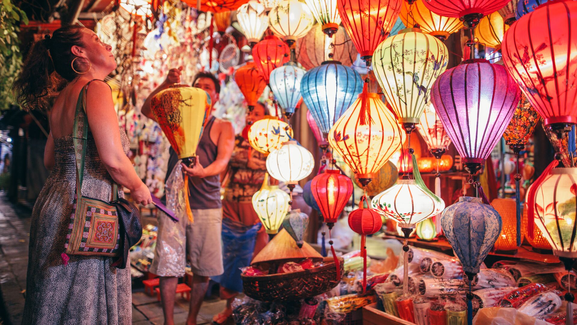 A woman admires glowing lanterns in Hoi An, Vietnam