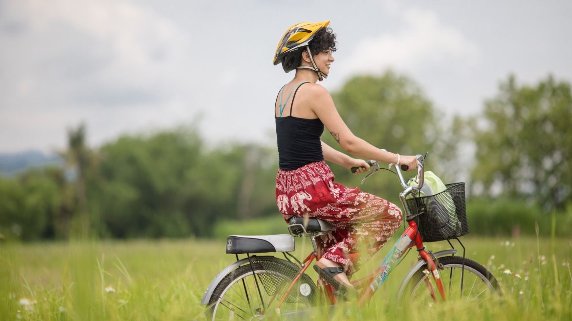 A woman cycling in the Thai countryside