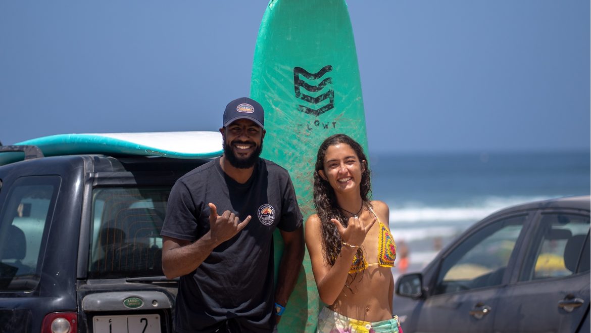 Momo and India give the camera a shaka after their surf lesson in Taghazout, Morocco