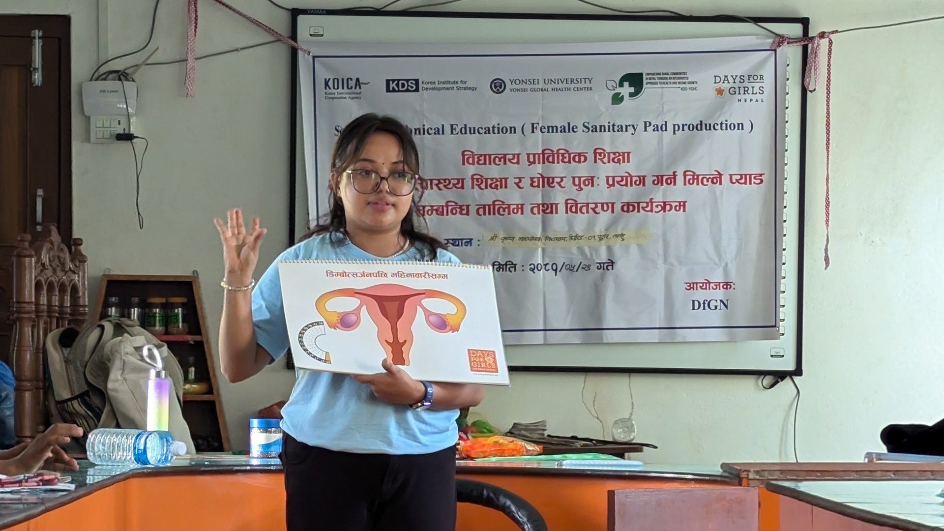 A Days for Girls staff member teaches a group about menstruation