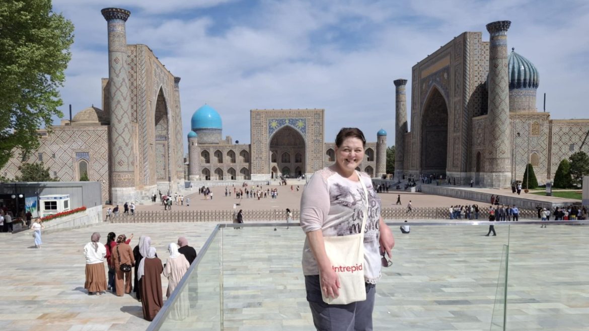 Carla posing in Samarkand with her Intrepid Travel tote bag