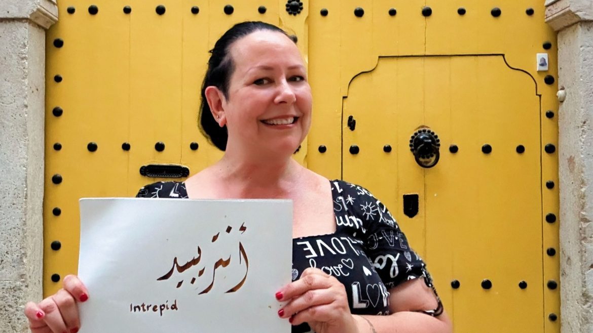 Writer Writer Liisa Ladouceur trying Intrepid's calligraphy class in Tunisia.