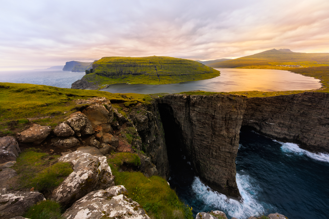 Lake Sørvágsvatn lit by sunset suspended over high cliffs in the Faroe Islands on the Traelanipan Trail