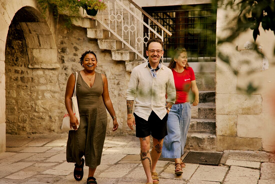 Travellers walking with Leader in the cobblestone streets of Split, Croatia