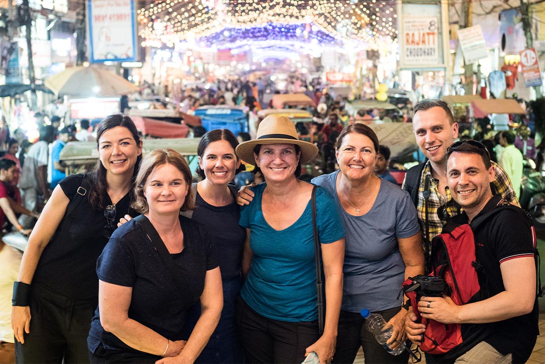 Group of travellers exploring the colourful markets in Madurai, India