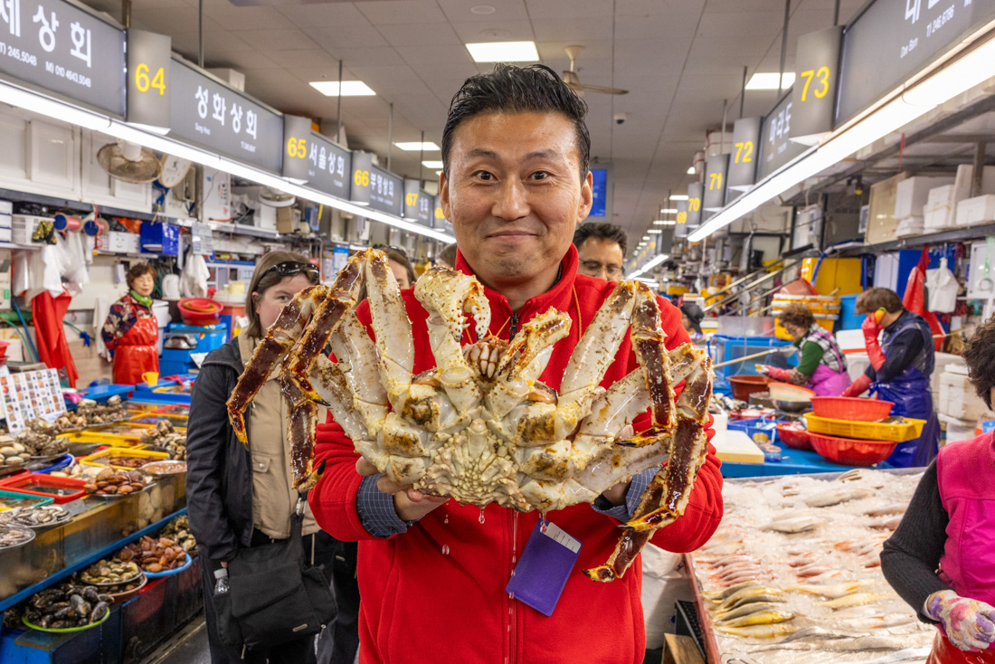 Leader holding huge crab in Jagalchi seafood market in Busan South Korea