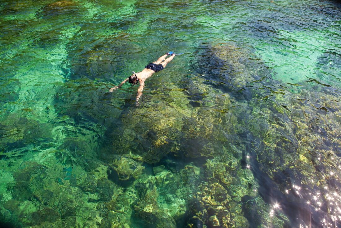 18 to 35 traveller snorkelling off Corfu looking down into the water in Greece