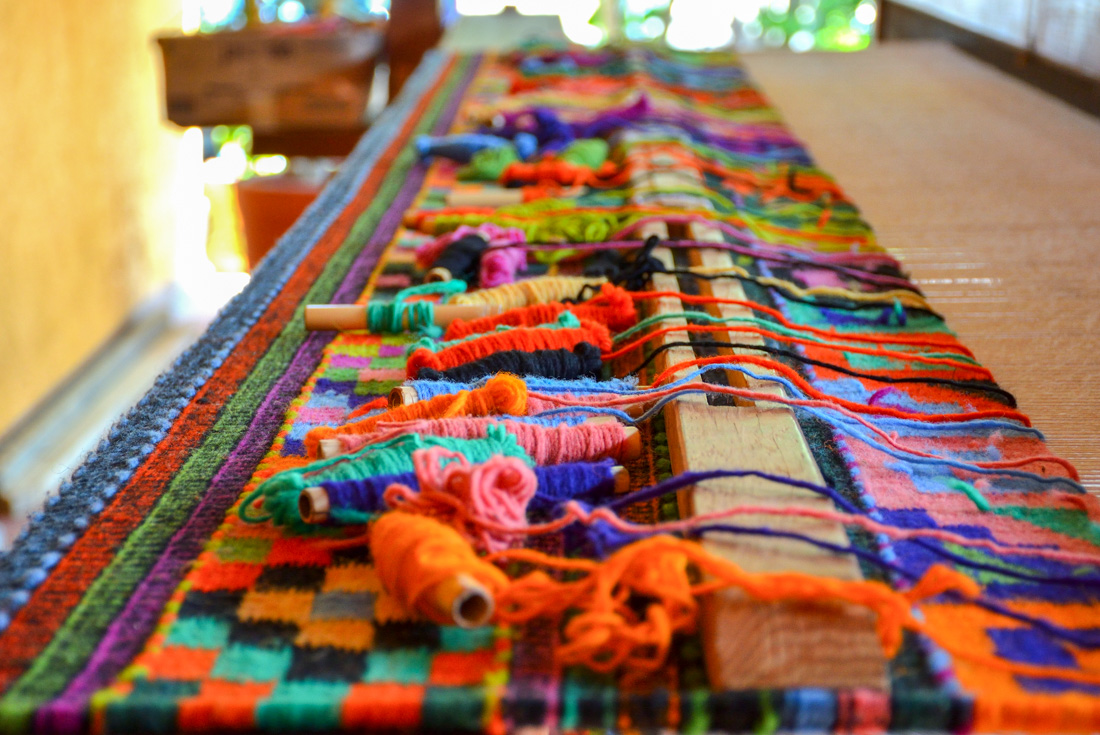 Teotitlan del Valle weaving setup with complex layout of spools of yarn