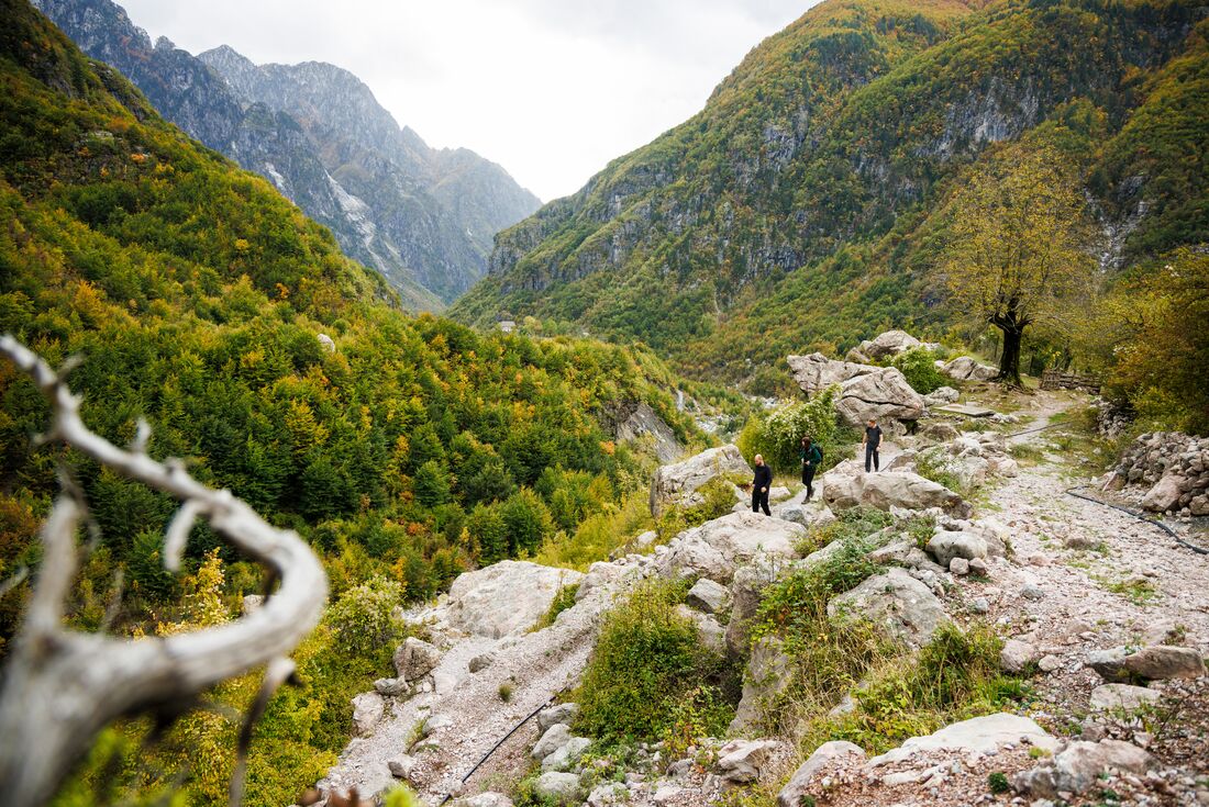 Intrepid travellers hiking in Theth National Park mountain valleys in Albania