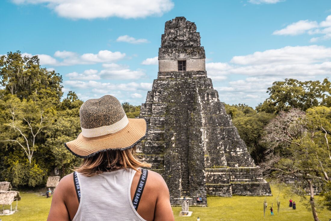 Intrepid traveller looks out at the looming Tikal Temple 