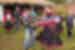 Group of travellers and locals dancing in traditional dress, Sacred Valley community visit, Peru