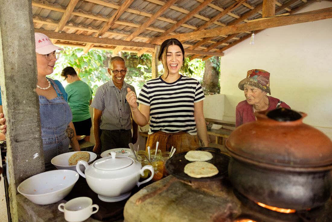 Travellers laughing with guide at the spice garden tour in Matale, Sri Lanka