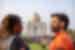 Travellers smile and laugh with each other looking out at the Taj Mahal in Agra