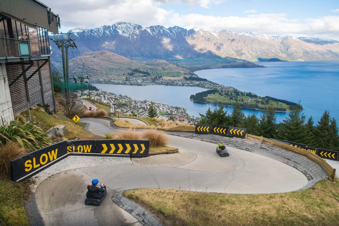 Travellers speeding downhill on luges in Queenstown, New Zealand