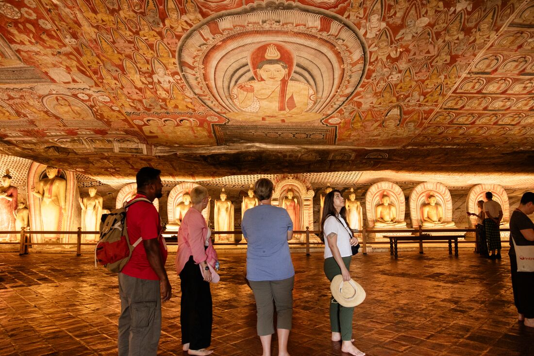 Interior of cave temple with Buddha art on the ceiling in Dambulla, Sri Lanka