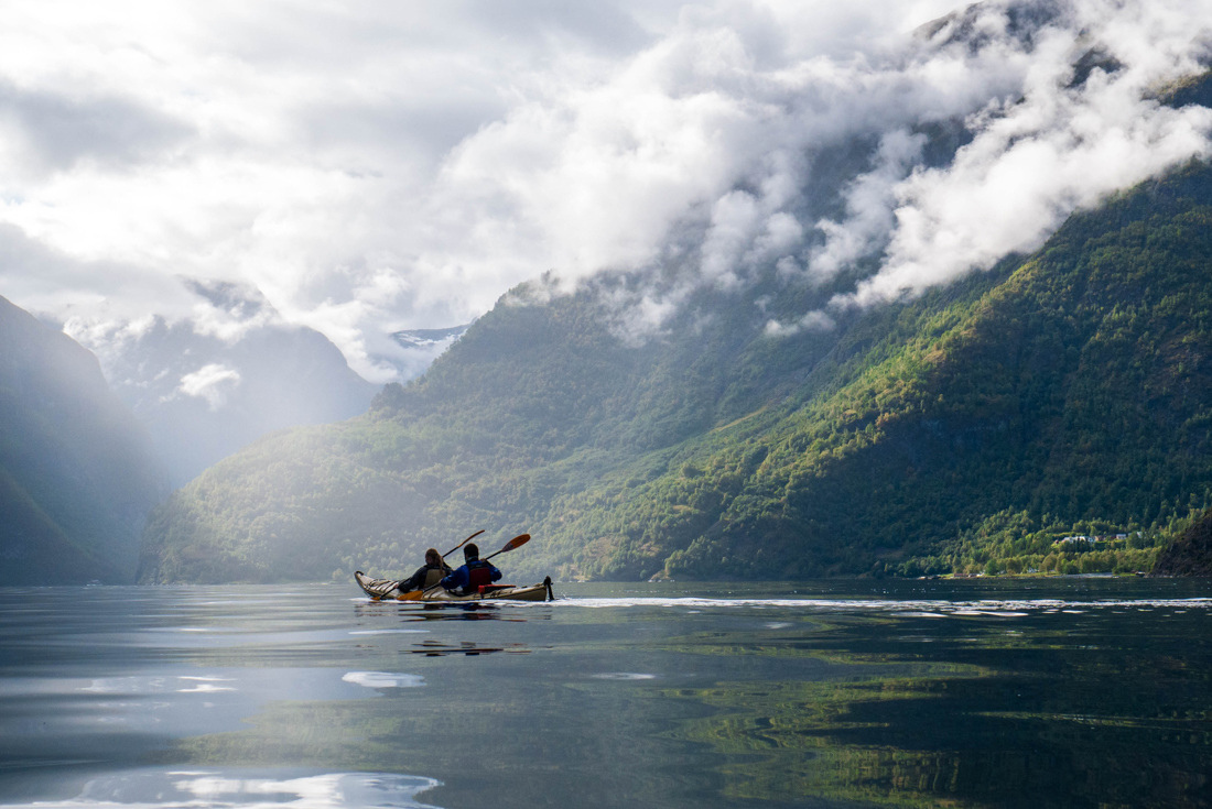 Intrepid travellers kayaking as a pair on Nærøyfjord on a tour of Norway