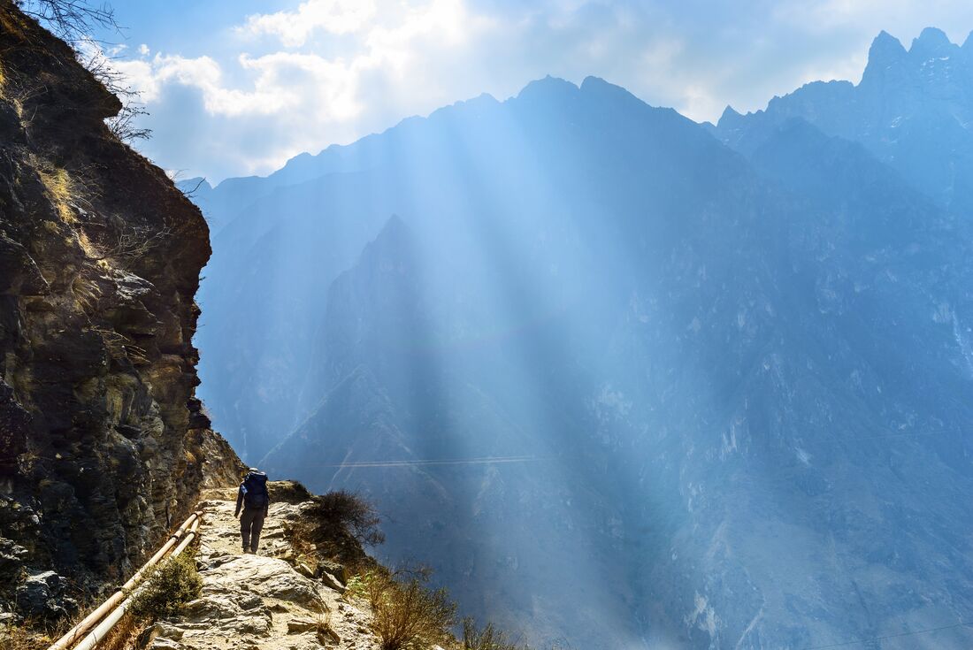 Sun streaming down while hiking in Tiger Leaping Gorge in Yunnan Province of China