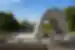 Closeup of arch in Hiroshima Memorial Peace Park with the A-Bomb Dome visible in background