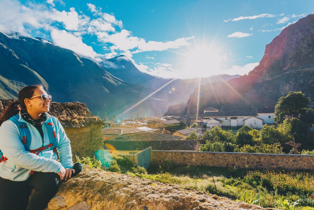 Intrepid traveller stops to rest and look out over the town of Ollantaytambo in Peru