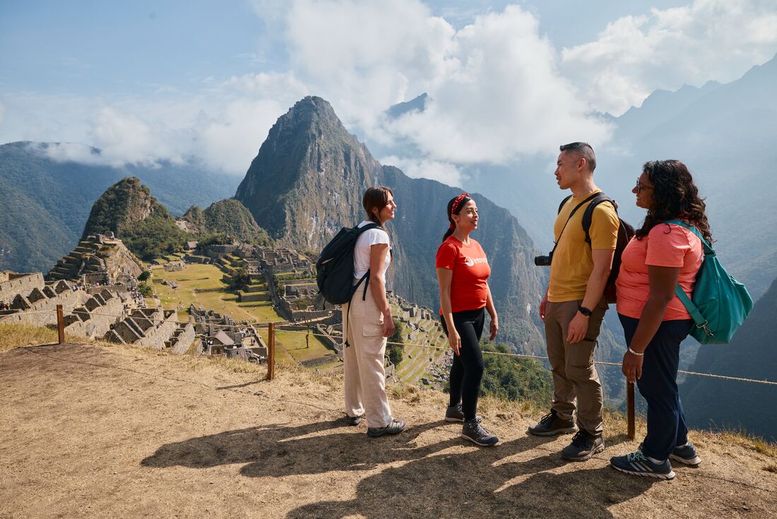 Intrepid leader talks to travellers as they stop in awe at Machu Picchu in Peru