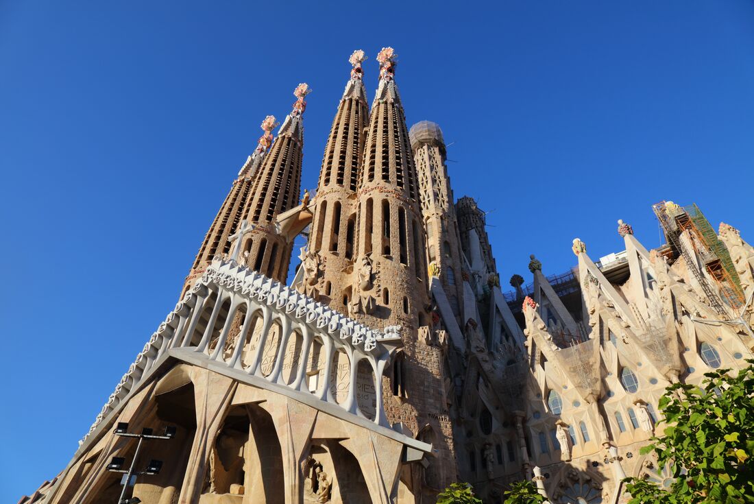 Grand view of the Sagrada Familia Church towers against a blue sky backdrop