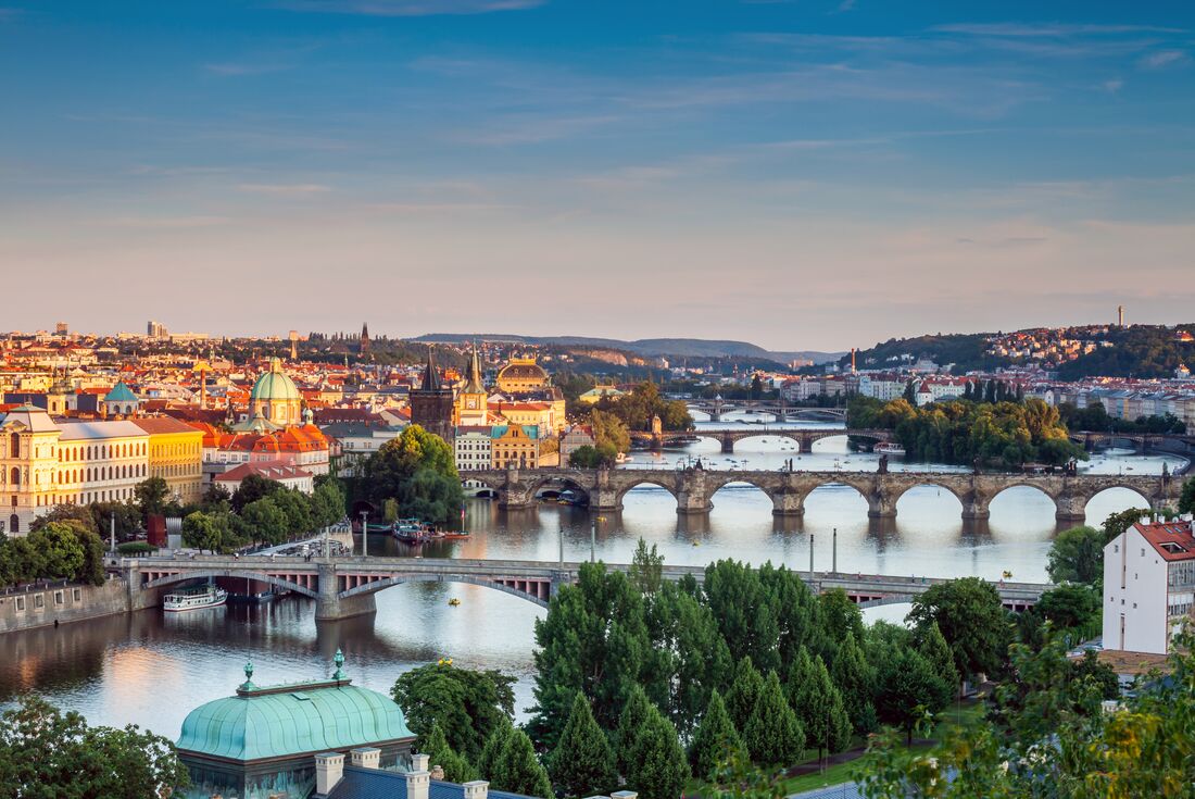 Aerial view of Prague Old Town with bridges over the river Vlatva in summer with sunset hitting the city