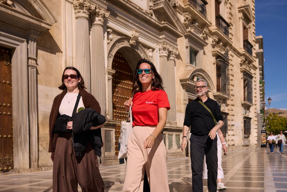 Intrepid leader and travellers walking through the plazas of Granada in Andalucia, southern Spain