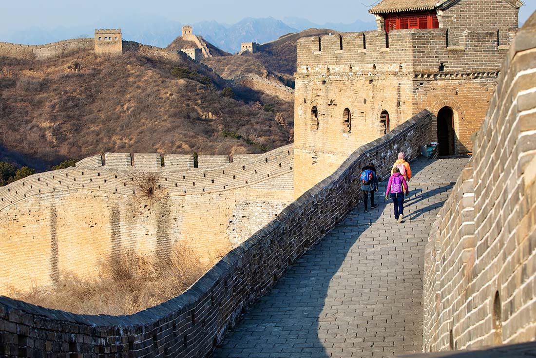 Great Wall of China with travellers walking in the background 
