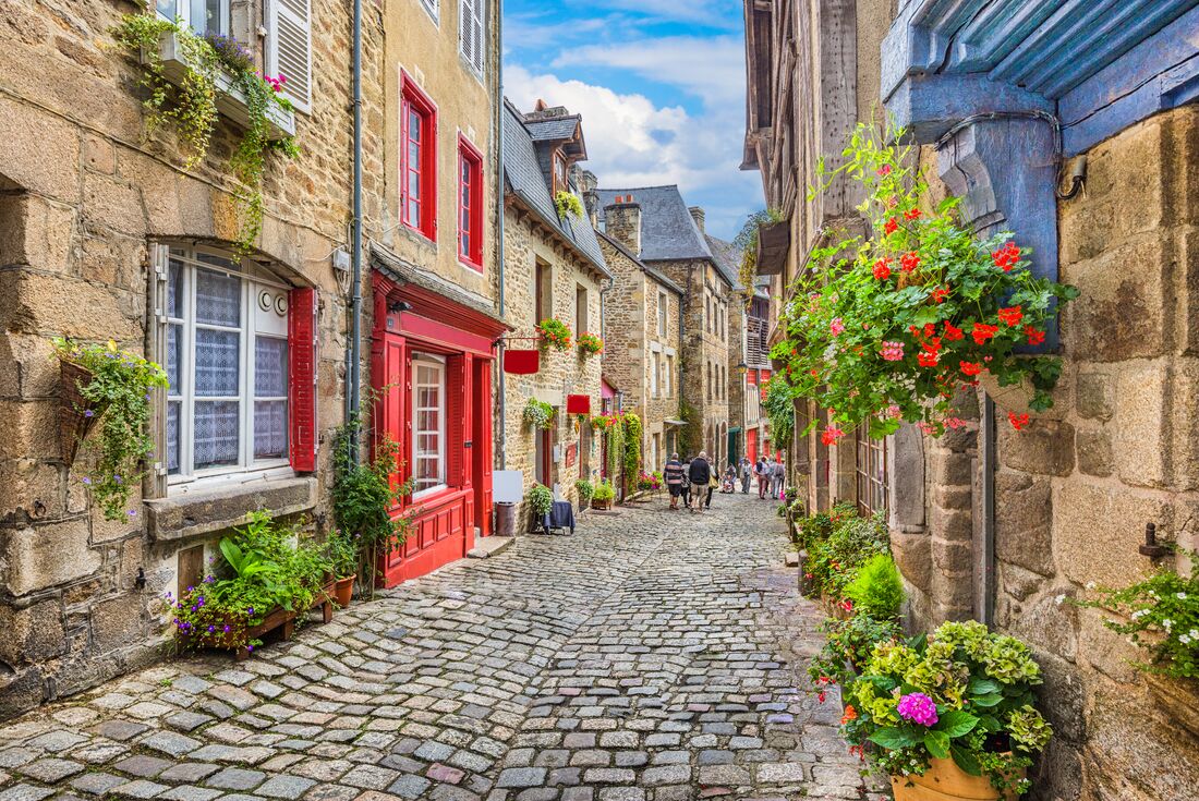 Cobble stone streets and houses with plants, Normandy, France